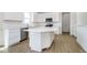 A bright kitchen with an island, stainless steel appliances, white cabinets, and tile backsplash at 815 Allandale Ave, Westfield, IN 46074