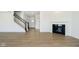 A living room features wood-look flooring, a fireplace, and an open staircase to the upper level at 815 Allandale Ave, Westfield, IN 46074