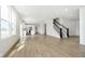 Open-concept living space with a kitchen, island, and staircase leading to the upper level at 815 Allandale Ave, Westfield, IN 46074