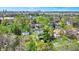 An aerial view of a neighborhood with mature trees and a cityscape in the background at 828 Woodruff Place Middle Dr, Indianapolis, IN 46201
