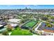 Aerial view of the Arsenal Tech High School campus with athletic fields and a cityscape background at 828 Woodruff Place Middle Dr, Indianapolis, IN 46201
