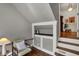 Cozy attic nook featuring a built-in desk area and a chair under the eaves at 828 Woodruff Place Middle Dr, Indianapolis, IN 46201