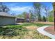 Landscaped backyard featuring mature trees, a well-manicured lawn and detached garage at 828 Woodruff Place Middle Dr, Indianapolis, IN 46201