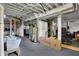 View of the unfinished basement with exposed pipes and equipment, featuring a laundry tub at 828 Woodruff Place Middle Dr, Indianapolis, IN 46201