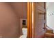 Small bathroom featuring a toilet, wood accents, and is conveniently located off of the staircase at 828 Woodruff Place Middle Dr, Indianapolis, IN 46201