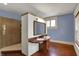 Bathroom featuring a unique vanity with a sink, a mirror, and a walk-in shower at 828 Woodruff Place Middle Dr, Indianapolis, IN 46201