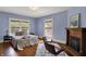 Serene bedroom with ample natural light, hardwood floors, and a decorative fireplace at 828 Woodruff Place Middle Dr, Indianapolis, IN 46201
