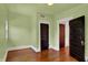 Bedroom featuring hardwood floors and closet doors at 828 Woodruff Place Middle Dr, Indianapolis, IN 46201