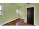 Bright bedroom featuring hardwood floors and natural light through two large windows at 828 Woodruff Place Middle Dr, Indianapolis, IN 46201