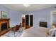 Cozy bedroom with a brick fireplace, hardwood floors, and a comfortable seating area at 828 Woodruff Place Middle Dr, Indianapolis, IN 46201