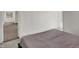 Cozy bedroom with neutral walls and carpet and large bed near an open doorway to a small room at 828 Woodruff Place Middle Dr, Indianapolis, IN 46201