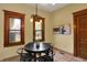 Cozy dining room featuring a round table, black chairs, and natural lighting from wood-framed windows at 828 Woodruff Place Middle Dr, Indianapolis, IN 46201