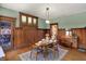 Charming dining room with paneled walls, elegant lighting, and a set table for meals at 828 Woodruff Place Middle Dr, Indianapolis, IN 46201