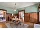 Spacious dining room with wood-paneled walls, original trim, and set table at 828 Woodruff Place Middle Dr, Indianapolis, IN 46201