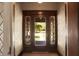 Beautiful entryway with patterned wallpaper and wood framed view to the exterior at 828 Woodruff Place Middle Dr, Indianapolis, IN 46201