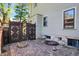 Exterior of the home with brick patio, decorative wooden gate and access to the basement at 828 Woodruff Place Middle Dr, Indianapolis, IN 46201
