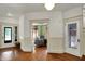 Spacious foyer showcasing hardwood floors, decorative doors, and inviting living space views at 828 Woodruff Place Middle Dr, Indianapolis, IN 46201