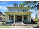 Beautiful two-story home boasts a welcoming front porch with classic architectural details at 828 Woodruff Place Middle Dr, Indianapolis, IN 46201
