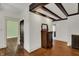 Hallway featuring wood floors, beamed ceiling, vintage dresser and classic radiator at 828 Woodruff Place Middle Dr, Indianapolis, IN 46201