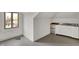 This is a bright kitchenette with stainless appliances, a window, and painted wood flooring at 828 Woodruff Place Middle Dr, Indianapolis, IN 46201