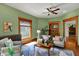 Inviting living room with wood trim, a ceiling fan, and a cozy seating area at 828 Woodruff Place Middle Dr, Indianapolis, IN 46201