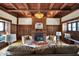 Bright living room showcasing original wood details, a brick fireplace, and a cozy seating area at 828 Woodruff Place Middle Dr, Indianapolis, IN 46201