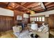Elegant living room features a brick fireplace, wood trim, coffered ceilings, and stylish seating at 828 Woodruff Place Middle Dr, Indianapolis, IN 46201