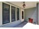 Charming covered porch with an ornate hanging light fixture and large windows at 828 Woodruff Place Middle Dr, Indianapolis, IN 46201