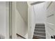 Well-lit stairway with freshly painted gray stairs and traditional white trim at 828 Woodruff Place Middle Dr, Indianapolis, IN 46201
