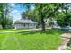 Home featuring a large, well-maintained lawn and mature trees at 952 N Concord St, Indianapolis, IN 46222