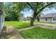 Home featuring a large, well-maintained lawn and mature trees at 952 N Concord St, Indianapolis, IN 46222
