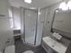 Bathroom featuring a glass shower, white vanity sink, and neutral wall color at 952 N Concord St, Indianapolis, IN 46222