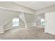 Spacious bedroom featuring two windows, neutral carpet, angled ceilings, and a closet at 952 N Concord St, Indianapolis, IN 46222