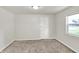 Well-lit bedroom featuring new carpet and a bright window at 952 N Concord St, Indianapolis, IN 46222