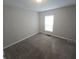 Neutral carpeted bedroom with bright window, ideal for relaxation and rest at 952 N Concord St, Indianapolis, IN 46222