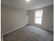 Cozy bedroom with neutral walls and carpet, plus natural light from the window at 952 N Concord St, Indianapolis, IN 46222