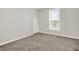 Neutral bedroom with a large window and comfortable carpet at 952 N Concord St, Indianapolis, IN 46222