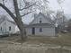Charming home featuring light siding, a blue front door, and mature trees at 952 N Concord St, Indianapolis, IN 46222