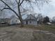 A charming house with light siding, a blue door, and a yard at 952 N Concord St, Indianapolis, IN 46222