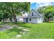 Home featuring a well-maintained lawn, and blue front door at 952 N Concord St, Indianapolis, IN 46222