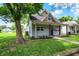 Charming home featuring a cozy front porch, well-maintained lawn, and mature trees at 952 N Concord St, Indianapolis, IN 46222