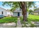 Charming home featuring a large tree, front lawn, and a blue front door at 952 N Concord St, Indianapolis, IN 46222