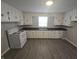 Clean kitchen with white cabinets, laminate counters, and space-saving design at 952 N Concord St, Indianapolis, IN 46222