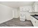 Bright kitchen with white cabinets, modern appliances, and durable gray flooring at 952 N Concord St, Indianapolis, IN 46222