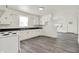 Bright kitchen featuring white cabinets, dark countertops, and gray laminate floors at 952 N Concord St, Indianapolis, IN 46222