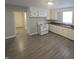Efficient kitchen featuring white cabinets, laminate countertops, and durable wood-look floors at 952 N Concord St, Indianapolis, IN 46222