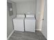 This laundry area features a washer and dryer on grey flooring at 952 N Concord St, Indianapolis, IN 46222