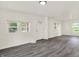 Bright living room with fresh paint, modern gray floors, and three big windows at 952 N Concord St, Indianapolis, IN 46222