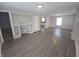 Spacious living room features wood-look floors, neutral paint, and built-in shelving at 952 N Concord St, Indianapolis, IN 46222