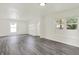Bright living room with fresh paint, modern gray floors, and three big windows at 952 N Concord St, Indianapolis, IN 46222